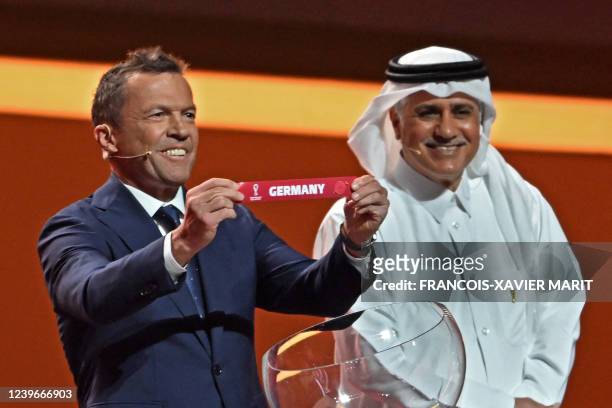 Former German footballer and World Cup winner Lothar Matthaus holds the card showing the name of Germany during the draw for the 2022 World Cup in...