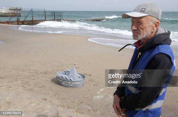 Metal ship made of buckets and a man are seen on the beach during an event dedicated to the April Fools' Day in Odessa, Ukraine on April 01, 2022.
