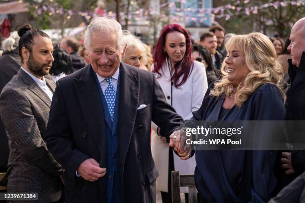 Prince Charles, Prince of Wales speaks to actor Letitia Dean during a visit to the set of EastEnders at Elstree Studios on March 31, 2022 in...