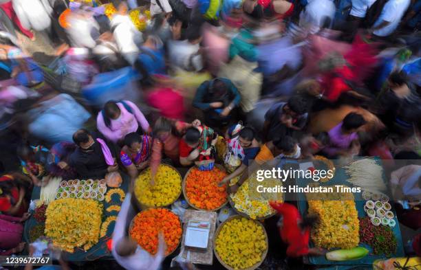 Shoppers crowd to buy flowers at the market on the eve of Gudi Padwa festival, the New Year for Maharashtians, outside Dadar Station on April 1, 2022...