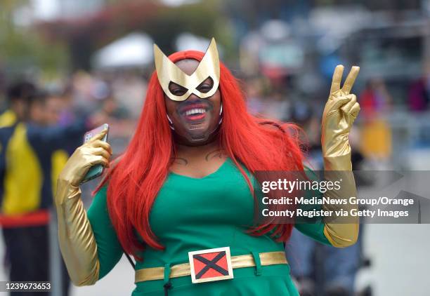 Anaheim, CA Ashley Mitchell gestures to people as she enters WonderCon dressed as Jean Grey from X-Men in Anaheim, CA, on Friday, April 1, 2022.