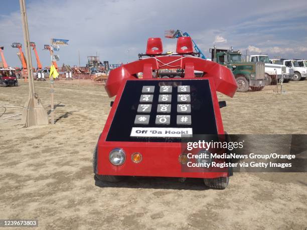 Black Rock Desert, NV A phone-shaped art car turns down a street within the tent district at Burning Man 2014 in Black Rock Desert.