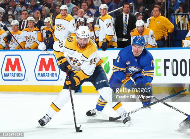 Roman Josi of the Nashville Predators controls the puck against Victor Olofsson of the Buffalo Sabres during an NHL game on April 1, 2022 at KeyBank...