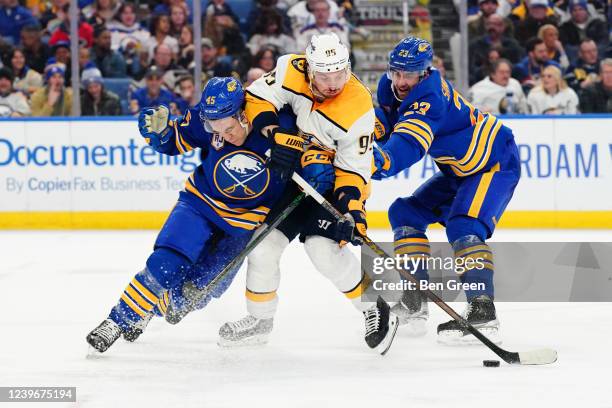 Casey Fitzgerald and Mattias Samuelsson of the Buffalo Sabres defend against Matt Duchene of the Nashville Predators during an NHL game on April 1,...