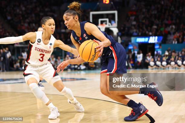 Evina Westbrook of the Connecticut Huskies drives to the basket against Anna Wilson of the Stanford Cardinal during the semifinals of the NCAA...