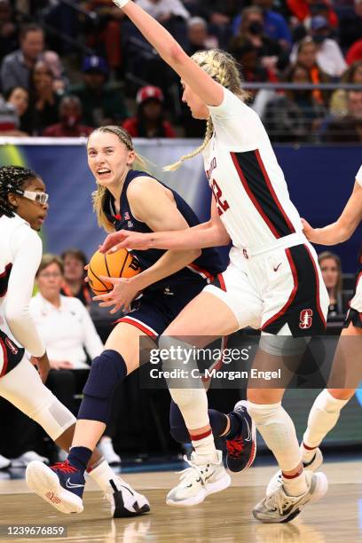 Paige Bueckers of the Connecticut Huskies drives to the basket against Cameron Brink of the Stanford Cardinal during the semifinals of the NCAA...