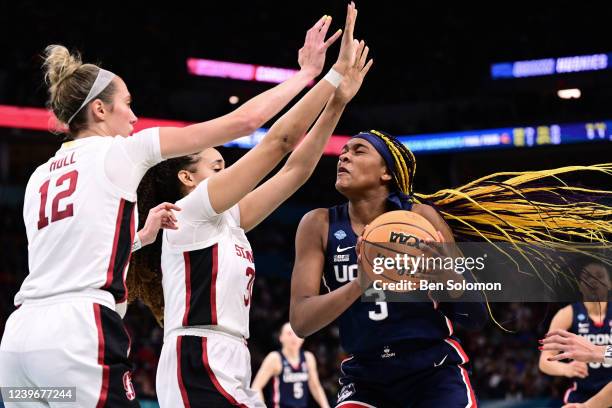 Aaliyah Edwards of the Connecticut Huskies tries to shoot over Lexie Hull and Haley Jones of the Stanford Cardinal during the semifinals of the NCAA...