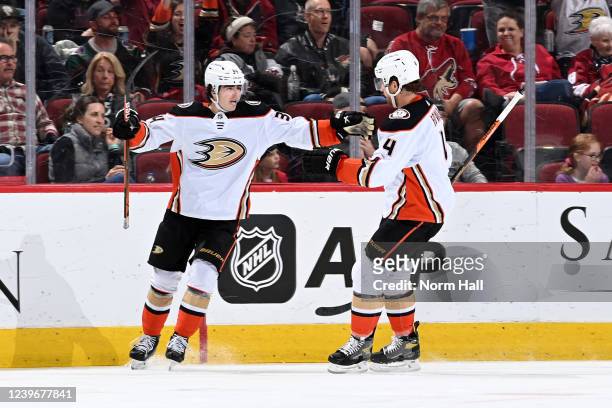 Cam Fowler of the Anaheim Ducks celebrates with Jamie Drysdale after scoring a goal against the Arizona Coyotes during the second period at Gila...
