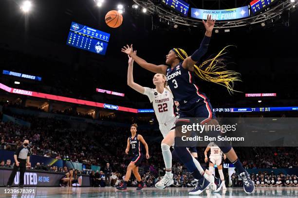Cameron Brink of the Stanford Cardinal and Aaliyah Edwards of the UConn Huskies compete for a rebound during the semifinals of the NCAA Womens...