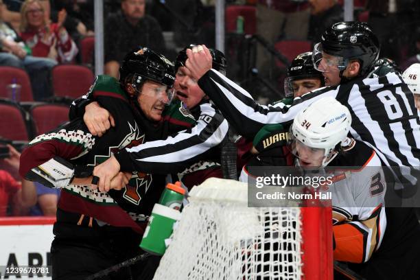 Linesmen Jonathan Deschamps and Ryan Daisy break up a fight between Jay Beagle of the Arizona Coyotes and Jamie Drysdale of the Anaheim Ducks during...