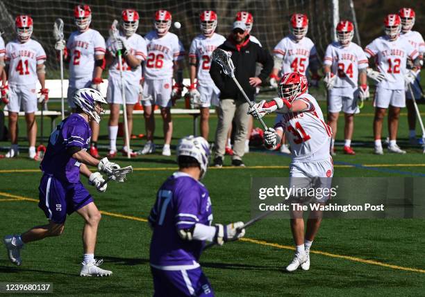 St. Johns Mac Haley, right, takes a shot on goal during the second quarter in a boys lacrosse game between Gonzaga and St. Johns College High School...