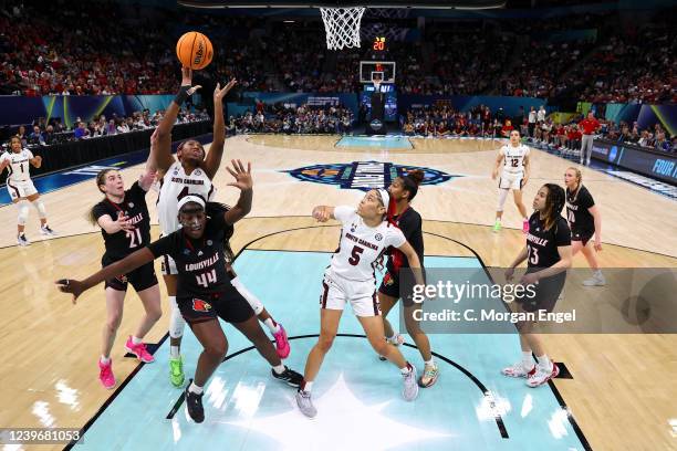 Aliyah Boston of the South Carolina Gamecocks reaches for a rebound over Olivia Cochran of the Louisville Cardinals during the semifinals of the NCAA...