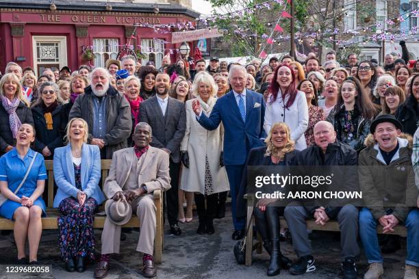 Britain's Camilla, Duchess of Cornwall and Britain's Prince Charles, Prince of Wales pose for a a group photo of cast and crew during a visit to the...