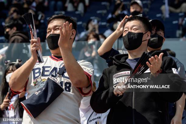 Supporters of the Doosan Bears applaud before a match between Hanwha Eagles and Doosan Bears on the first day of the 2022 Korea Baseball Organization...