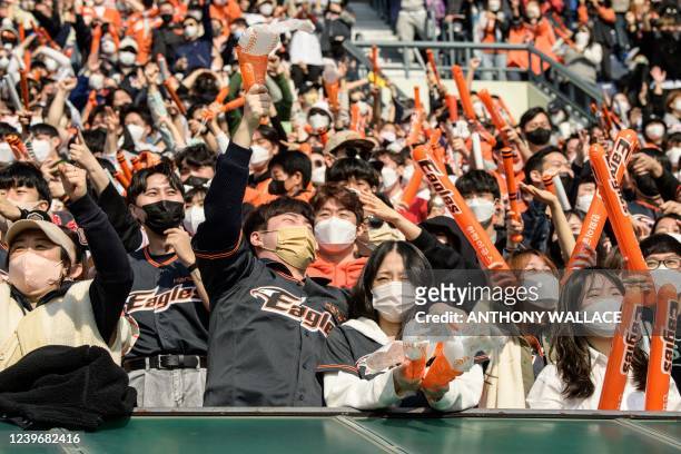 Supporters of the Hanwha Eagles react during a match between Hanwha Eagles and Doosan Bears on the first day of the 2022 Korea Baseball Organization...