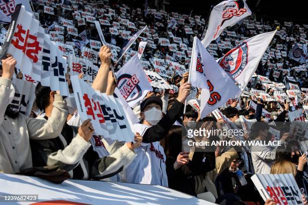 Supporters of the Doosan Bears react during a match between Hanwha Eagles and Doosan Bears on the first day of the 2022 Korea Baseball Organization...