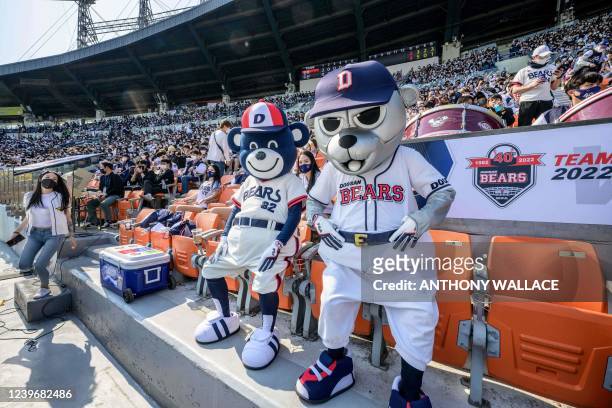 Performers dressed as team mascots of the Doosan Bears react during a match between Hanwha Eagles and Doosan Bears on the first day of the 2022 Korea...