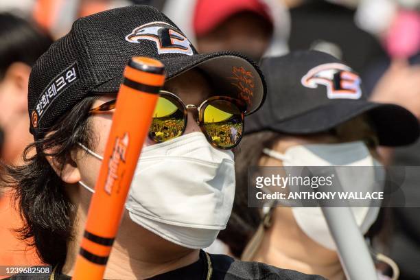 Supporters of the Hanwha Eagles react during a match between Hanwha Eagles and Doosan Bears on the first day of the 2022 Korea Baseball Organization...