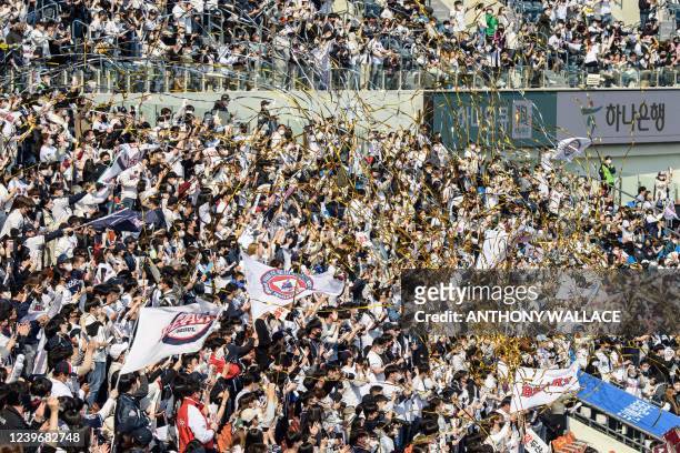 Supporters of the Doosan Bears react during a match between Hanwha Eagles and Doosan Bears on the first day of the 2022 Korea Baseball Organization...