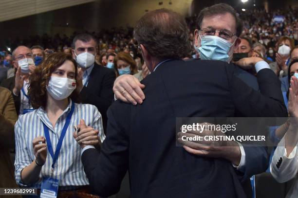 The regional president of Madrid, Isabel Diaz Ayuso winks at the newly elected president of PP, Alberto Nunez Feijoo as he hugs former Spanish Prime...