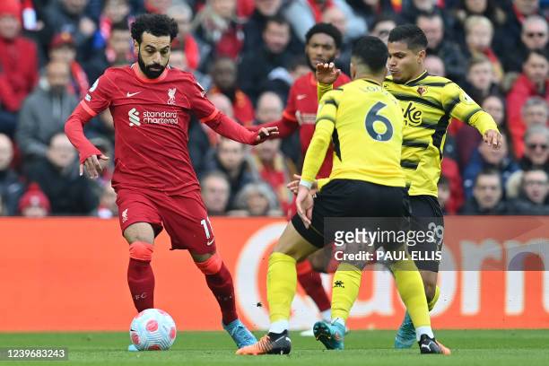 Liverpool's Egyptian midfielder Mohamed Salah vies with Watford's Moroccan midfielder Imran Louza and Watford's Colombian striker Cucho Hernandez...