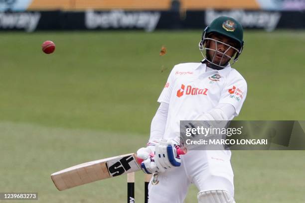 Bangladesh's Mehidy Hasan Miraz ducks under a bouncer ball delivered by South Africa's Duanne Olivier during the third day of the first Test cricket...