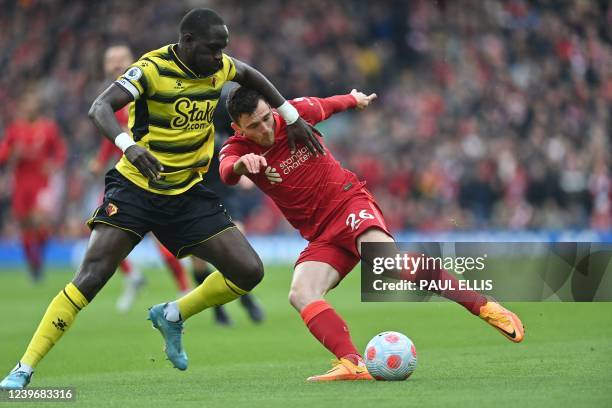 Watford's French midfielder Moussa Sissoko vies with Liverpool's Scottish defender Andrew Robertson during the English Premier League football match...