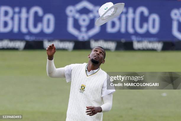 South Africa's Lizaad Williams throws his hat into the air during the third day of the first Test cricket match between South Africa and Bangladesh...