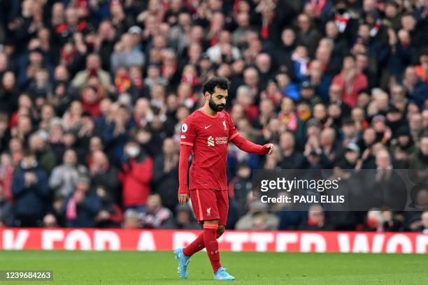 Liverpool's Egyptian midfielder Mohamed Salah reacts as he walks from the pitch having been substituted during the English Premier League football...