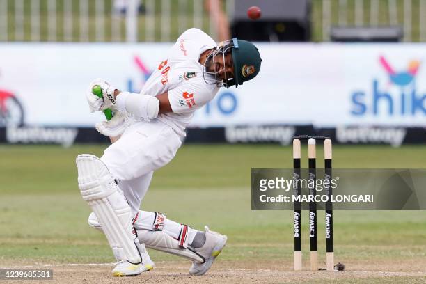 Bangladesh's Khaled Ahmed ducks under a bouncer ball delivered by South Africa's Duanne Olivier during the third day of the first Test cricket match...