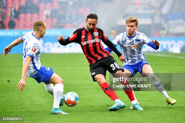 Leverkusen's German midfielder Karim Bellarabi , Hertha Berlin's Argentinian midfielder Santiago Ascacibar and Hertha Berlin's German defender...