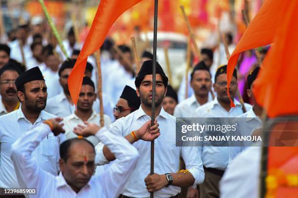 Hindu Rashtriya Swayamsevak Sangh volunteers march along a road during an event to mark the Hindu New Year in Allahabad on April 2, 2022.