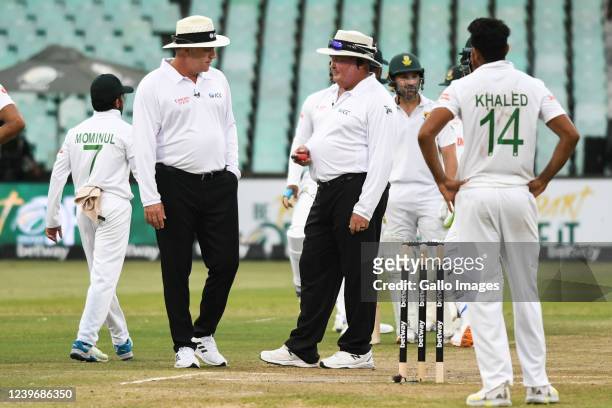 Umpires check the light during day 3 of the 1st ICC WTC2 Betway Test match between South Africa and Bangladesh at Hollywoodbets Kingsmead Stadium on...