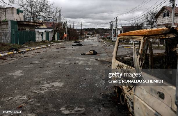 Graphic content / In this photo taken on April 02, 2022 bodies of civilian lie on Yablunska street in Bucha, northwest of Kyiv, after Russian army...