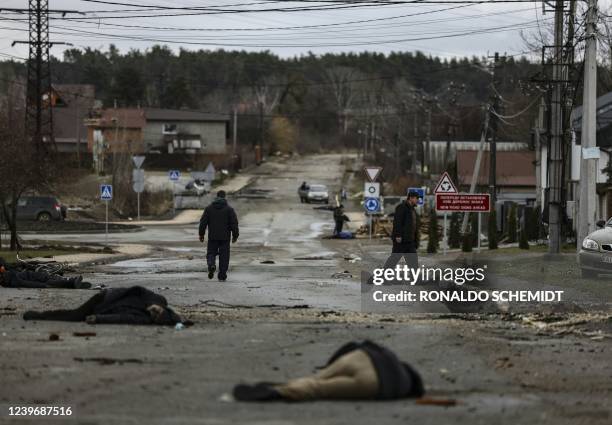 Graphic content / In this photo taken on April 2 bodies of civilians lie on Yablunska street in Bucha, northwest of Kyiv, after the Russian army...