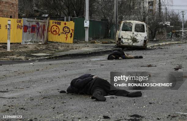 Graphic content / TOPSHOT - Dead bodies lie on a street in Bucha, northwest of Kyiv, on April 2 as Ukraine says Russian forces are making a "rapid...