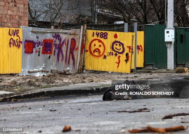 Graphic content / In this photo taken on April 02, 2022 the body of Mykhailo Kovalenko lies on Yablunska street in Bucha, northwest of Kyiv, after...