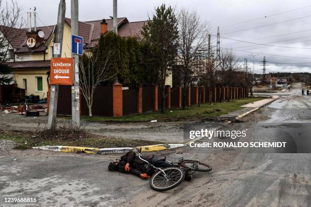 Graphic content / In file photo taken on April 02, 2022 the body of Mykhailo Romaniuk lies in Yablunska street next to his bicycle in Bucha,...