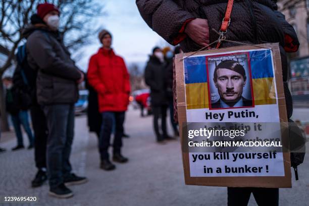 Demonstrator displays a placard depicting Russian President Vladimir Putin as Adolf Hitler during a protest against Russia's invasion of Ukraine, in...