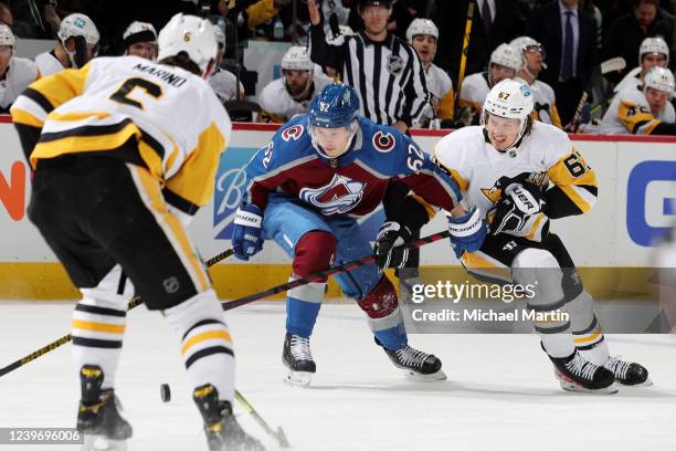 Artturi Lehkonen of the Colorado Avalanche skates against Rickard Rakell of the Pittsburgh Penguins at Ball Arena on April 2, 2022 in Denver,...