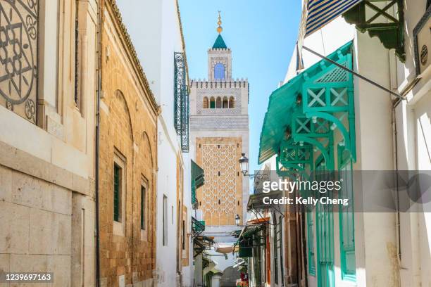 minaret of al-zaytuna mosque in the medina of tunis - tunisia medina stock pictures, royalty-free photos & images