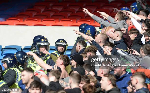 Riot police stand between the Swansea City fans during the Sky Bet Championship match between Cardiff City and Swansea City at Cardiff City Stadium...