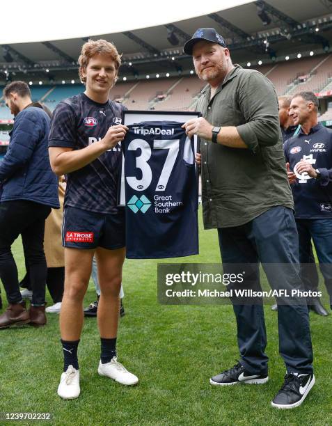 Debutant Jordan Boyd of the Blues is presented with his jumper by Lance Whitnall during the 2022 AFL Round 03 match between the Carlton Blues and the...