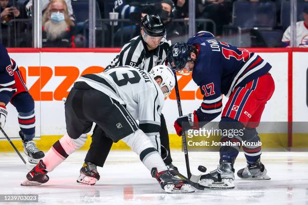 Adam Lowry of the Winnipeg Jets wins a second period face-off against Gabriel Valardi of the Los Angeles Kings at the Canada Life Centre on April 2,...