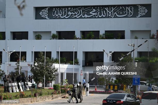 Security personnel arrive to deploy in front of Parliament House building in Islamabad on April 3, 2022 as Prime Minister Imran Khan called on his...