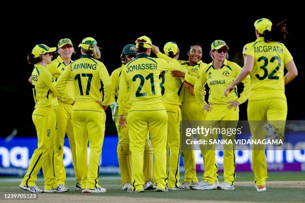 Australia's celebrate the dismissal of England's captain Heather Knight during the Women's Cricket World Cup final match between England and...