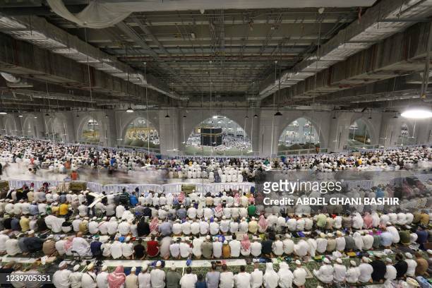Muslims pray at the Grand Mosque, with a view of the Kaaba, Islam's holiest shrine, in Saudi Arabia's city of Mecca on the first day of the fasting...