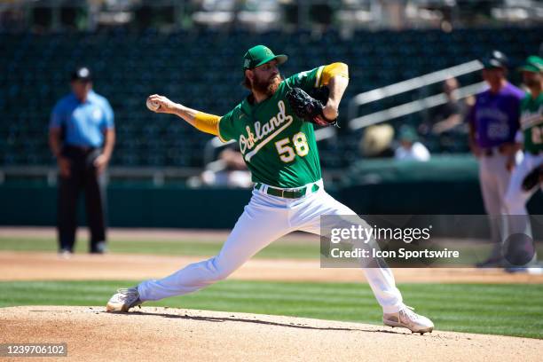 Paul Blackburn of the Oakland Athletics warms up for the first pitch during a Spring Training Baseball game between the Colorado Rockies and Oakland...