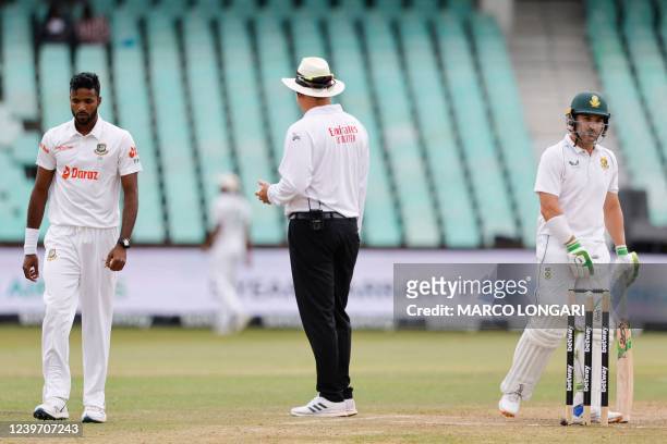 South African umpire Adrian Holdstock stands between Bangladesh's Ebadot Hossain and South Africa's Dean Elgar after an incident during the fourth...