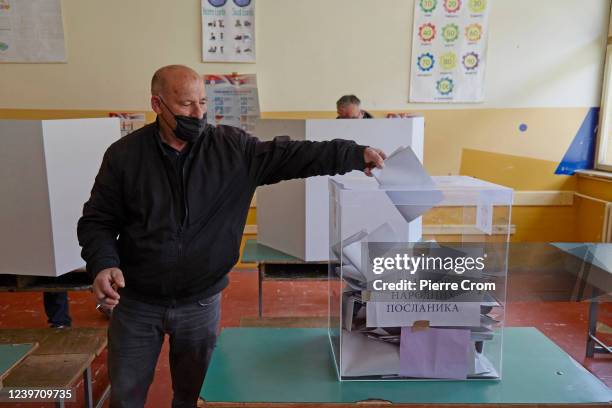 Serbian voter from Kosovo casts his ballot as hundreds of Serbian citizens from neighbouring Kosovo queue up to cast their ballot in a dedicated...